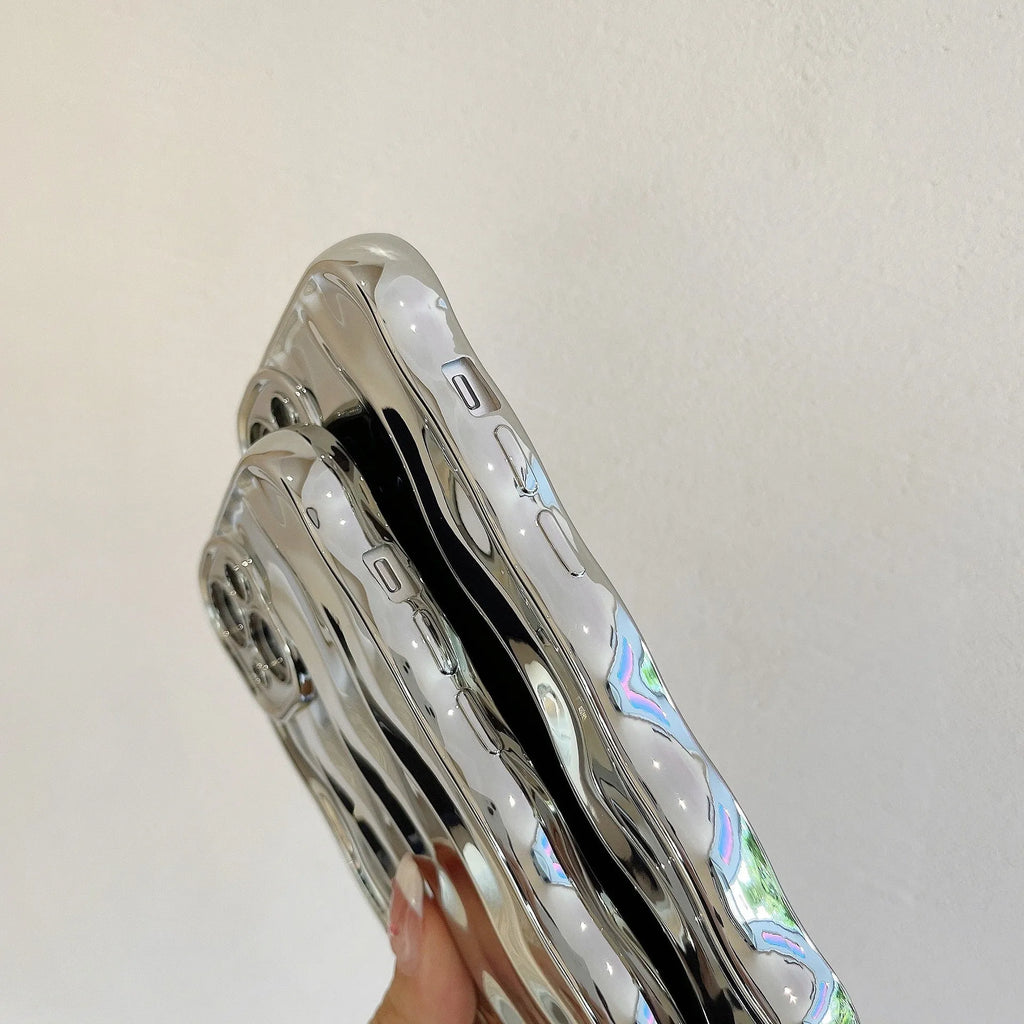 Silver electroplated iPhone 17 Pro Max case with raised three-dimensional wave stripe pattern on the back.