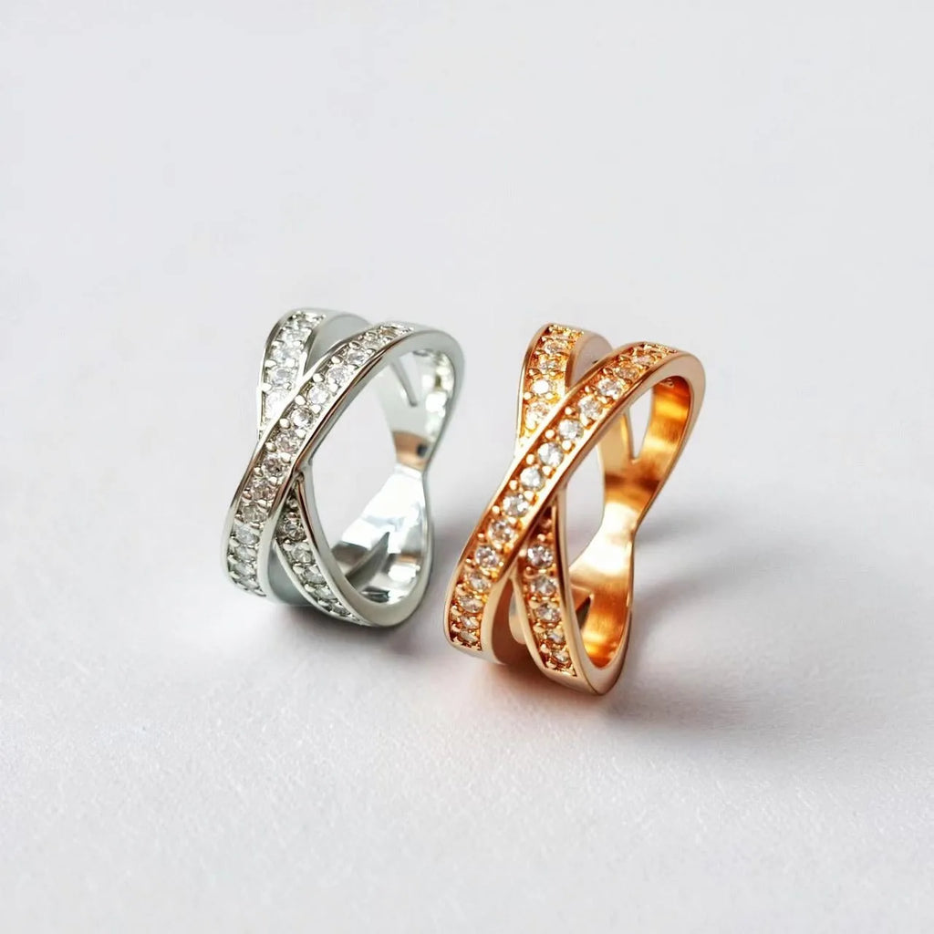 Silver and rose gold metal ring with a small cross design featuring micro-inlaid zircon stones.