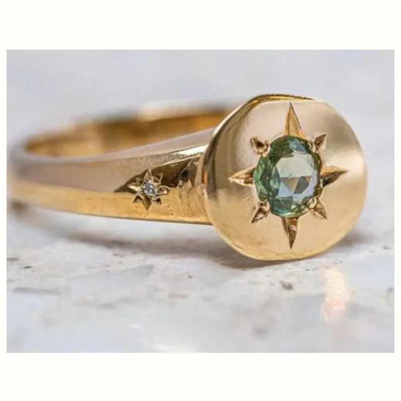 Gold-coloured adjustable ring featuring an oval star shape with a zircon stone.