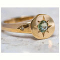 Gold-coloured adjustable ring featuring an oval star shape with a zircon stone.