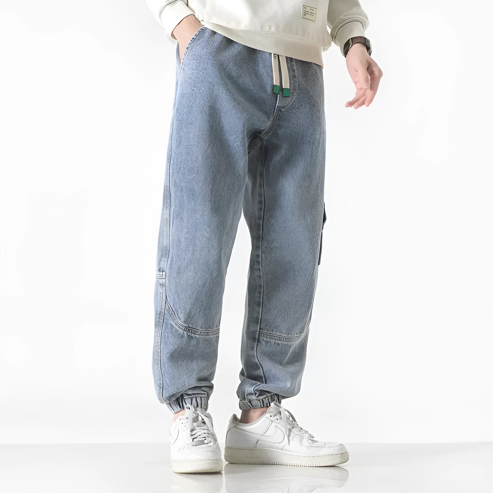 Men's loose-fit tapered cotton trousers in black, blue, and grey colours with mid-waist design