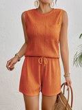 Women's apricot polyester vest and shorts set laid flat, showing round neck and elasticated waist.