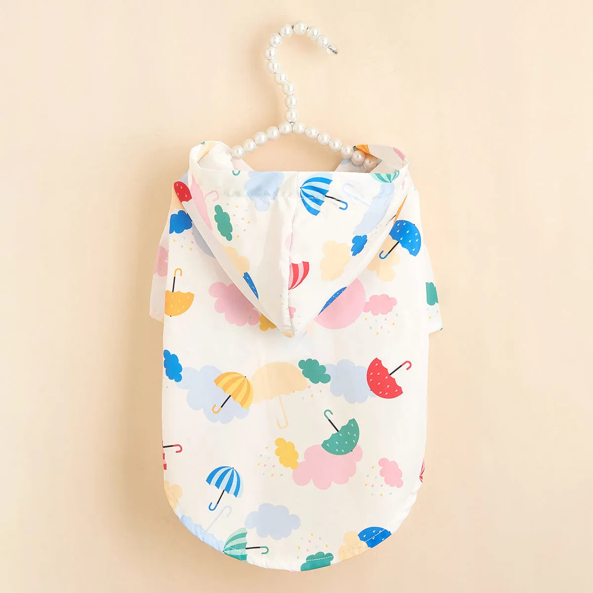 Colourful cartoon umbrella pattern dog raincoat in polyester fabric shown in multiple pet sizes