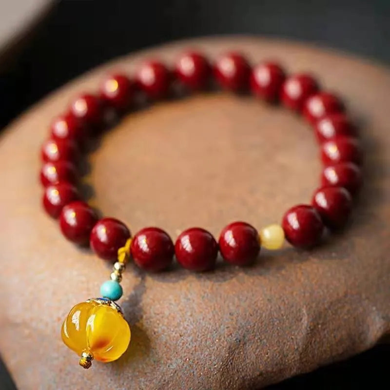 Wave-shaped bracelet with cinnabar segments and copper beads in national style design