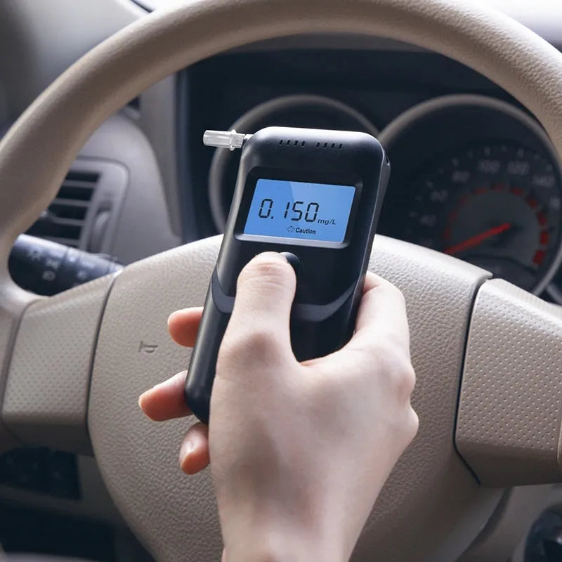 Black handheld household alcohol tester for breath checks and drunk driving detection