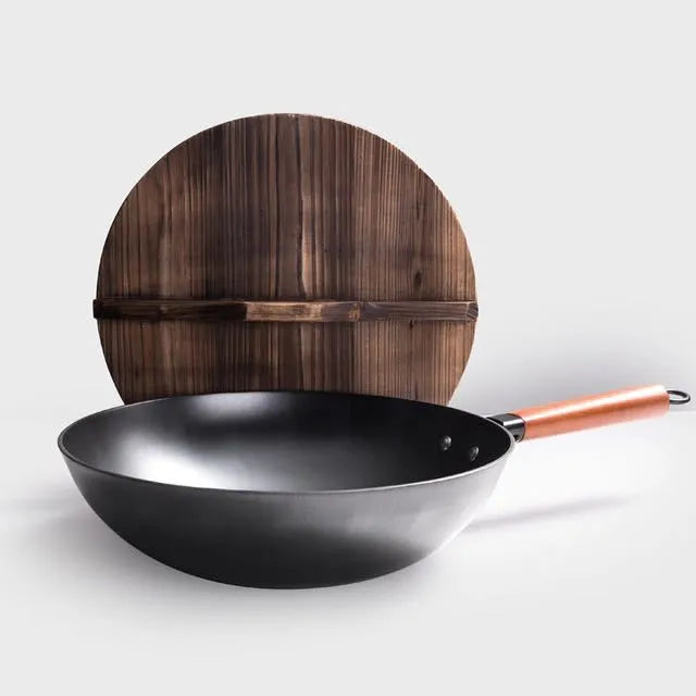 Traditional black iron wok pan with wooden handle measuring 32cm diameter
