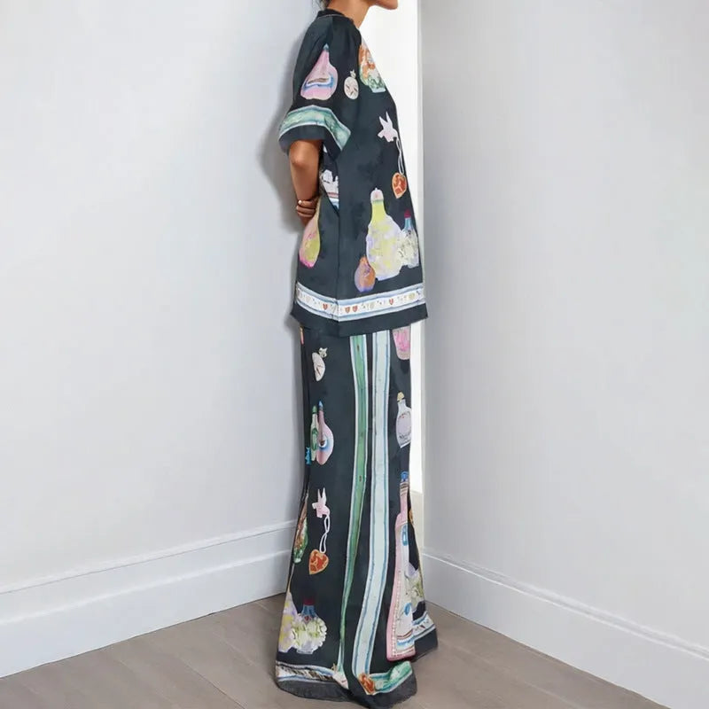 Black women's cardigan and trousers co-ord set with a cartoon pattern print.