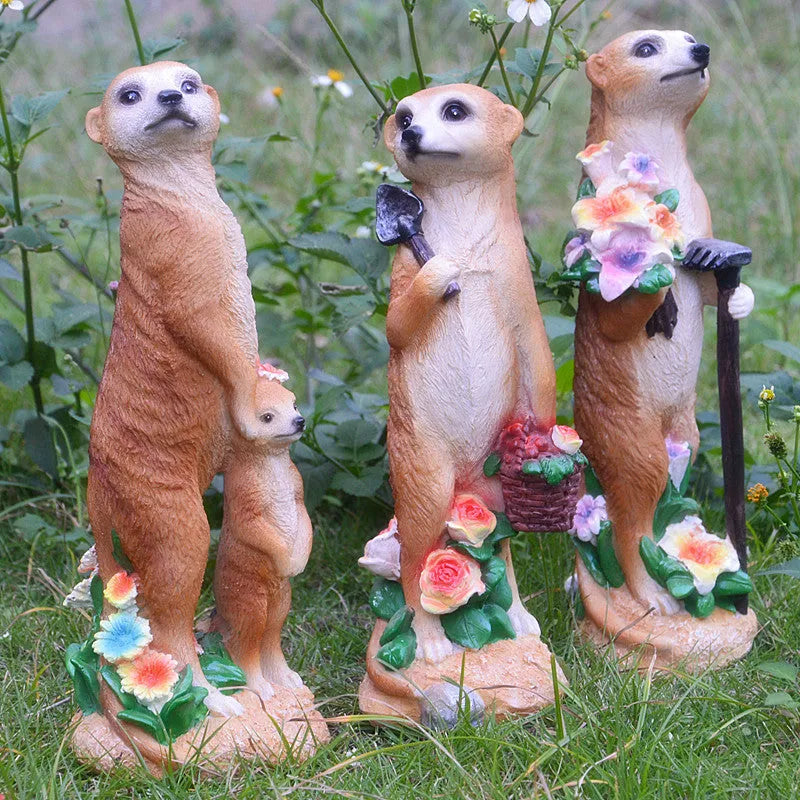 Three straw hat mongoose garden ornaments including mother and child, rake carrier, and shovel carrier designs