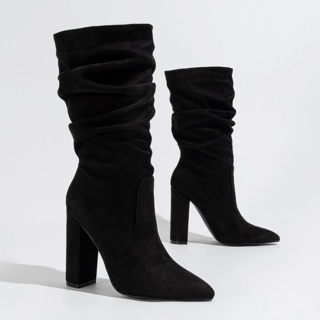 Women's black suede chunky high heel boots with pointed toe and oversleeve style.