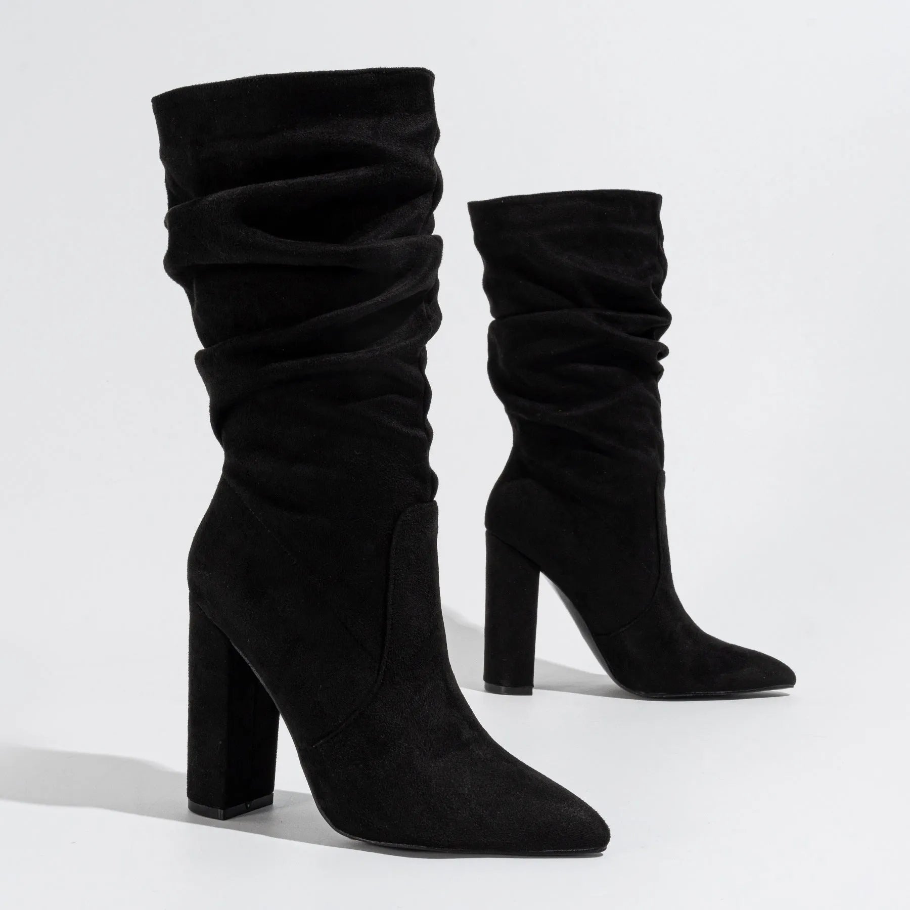 Women's black suede chunky high heel boots with pointed toe and oversleeve style.