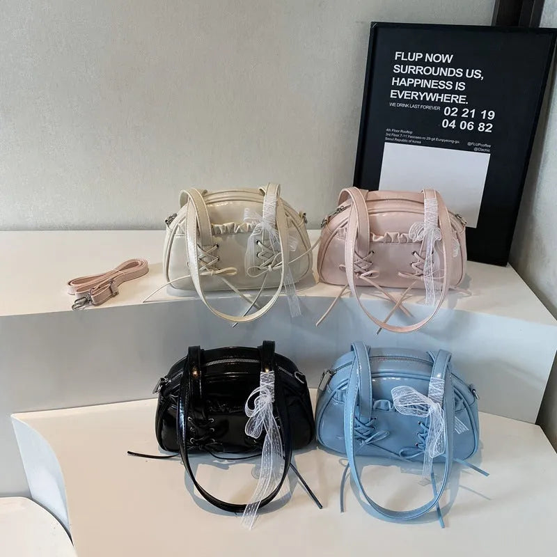 Women's casual shoulder handbag with bandage bow detail in PU material showing internal phone compartment