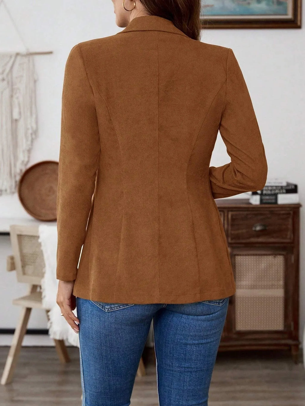 Brown single-breasted leisure blazer with lapel collar and long sleeves on a hanger.