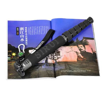 Black carbon fibre SLR camera monopod extended to full height with six sections visible