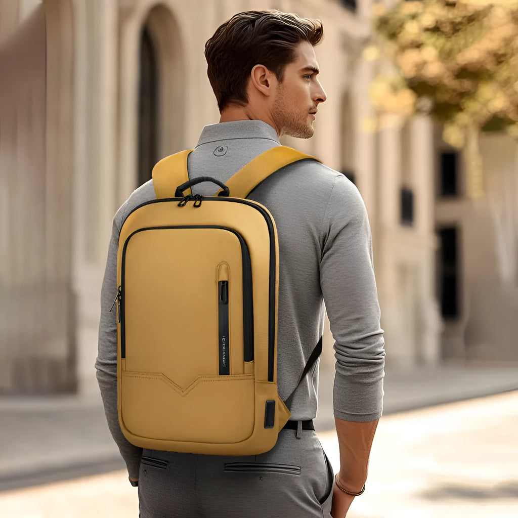Lightweight grey polyester computer backpack with USB charging port on the shoulder strap
