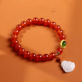Handcrafted women's bracelet with red agate stone, amber beads, jade and Buddha pendants.