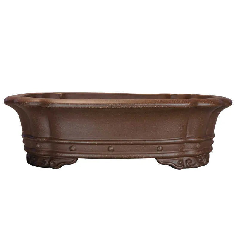 Handmade purple sand rectangular antique flower pot on a desktop.