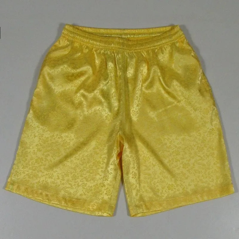 Man wearing traditional style black Tang suit shorts with an elastic drawstring waistband.