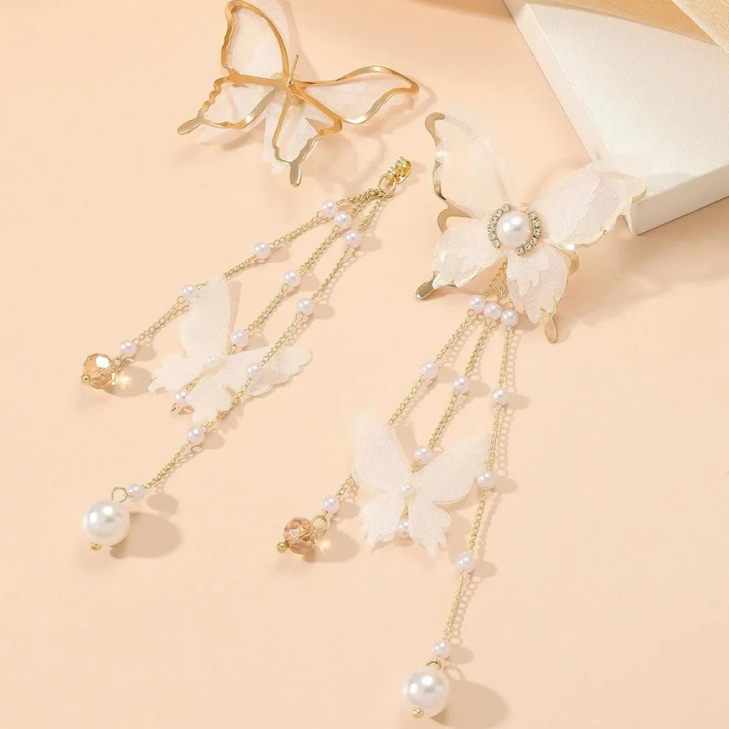 White butterfly-shaped earrings with lace patterns, pearl rhinestones, and a dangling tassel on a copper alloy base.