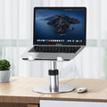 Silver adjustable car laptop stand with rotating base extended on a car seat.
