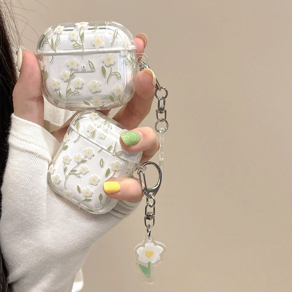 Transparent white floral patterned soft TPU protective case for Apple AirPods on a table.