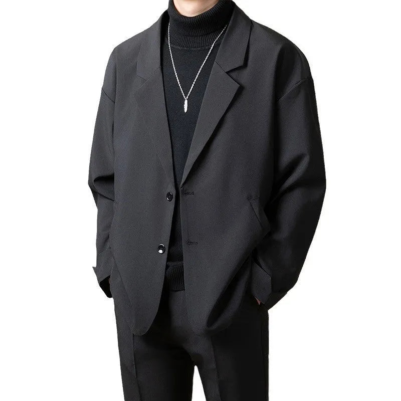 Men's loose fit casual suit jacket in a polyester blend fabric, shown in a light business style.