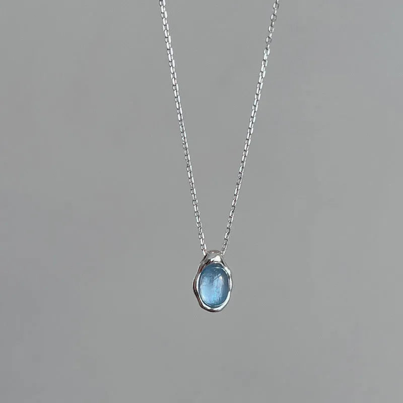 Women's navy blue geometric water drop pendant on an adjustable silver-toned chain.