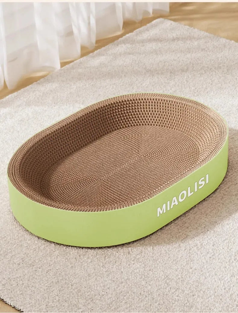 Green oval cat scratch nest measuring 55cm diameter made from corrugated paper