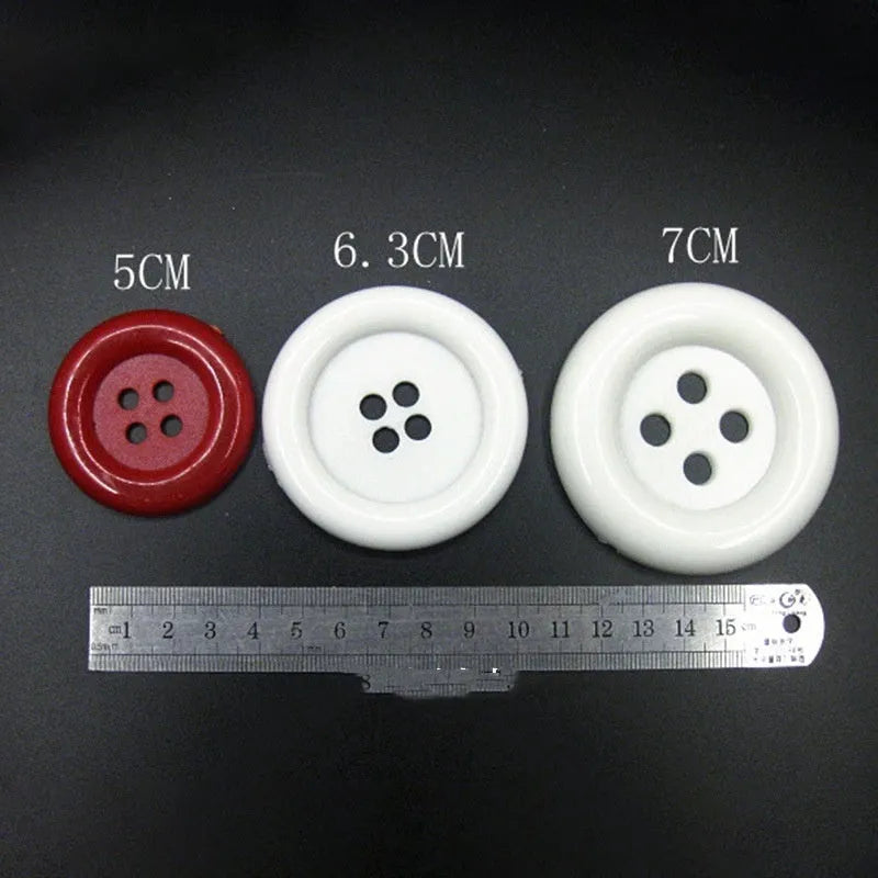 Large round plastic nylon buttons in multiple colours with four sewing holes for garment repair