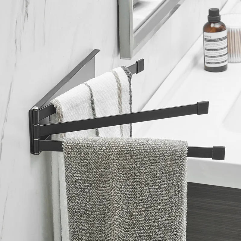 Nordic style folding towel rack in black mounted on bathroom wall with towels