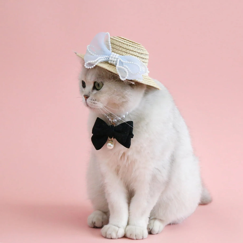 Pink pearl butterfly bow woven straw hat for a cat on a mannequin head.