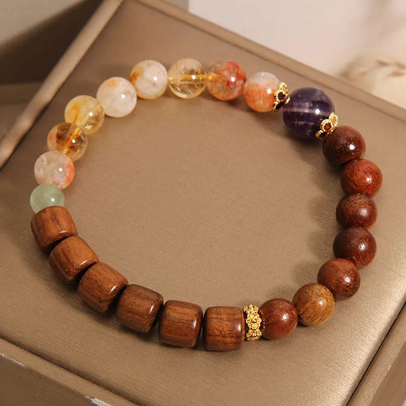Yellow tower crystal, ebony, and amethyst bead bracelet with pearl and rhinestone details.