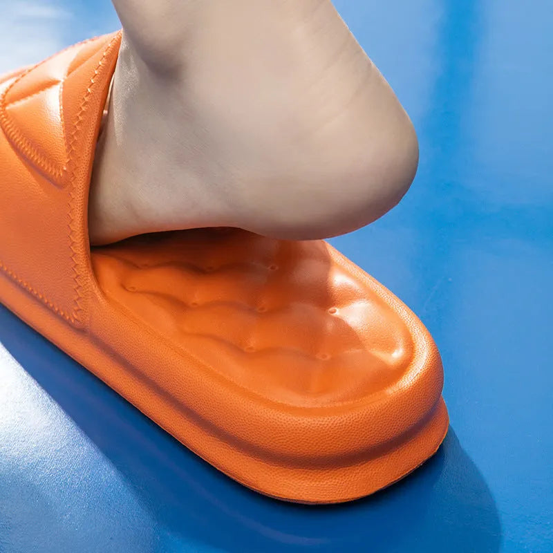 A pair of thick-sole EVA bathroom slippers in a choice of five colours, shown on a bathroom floor.