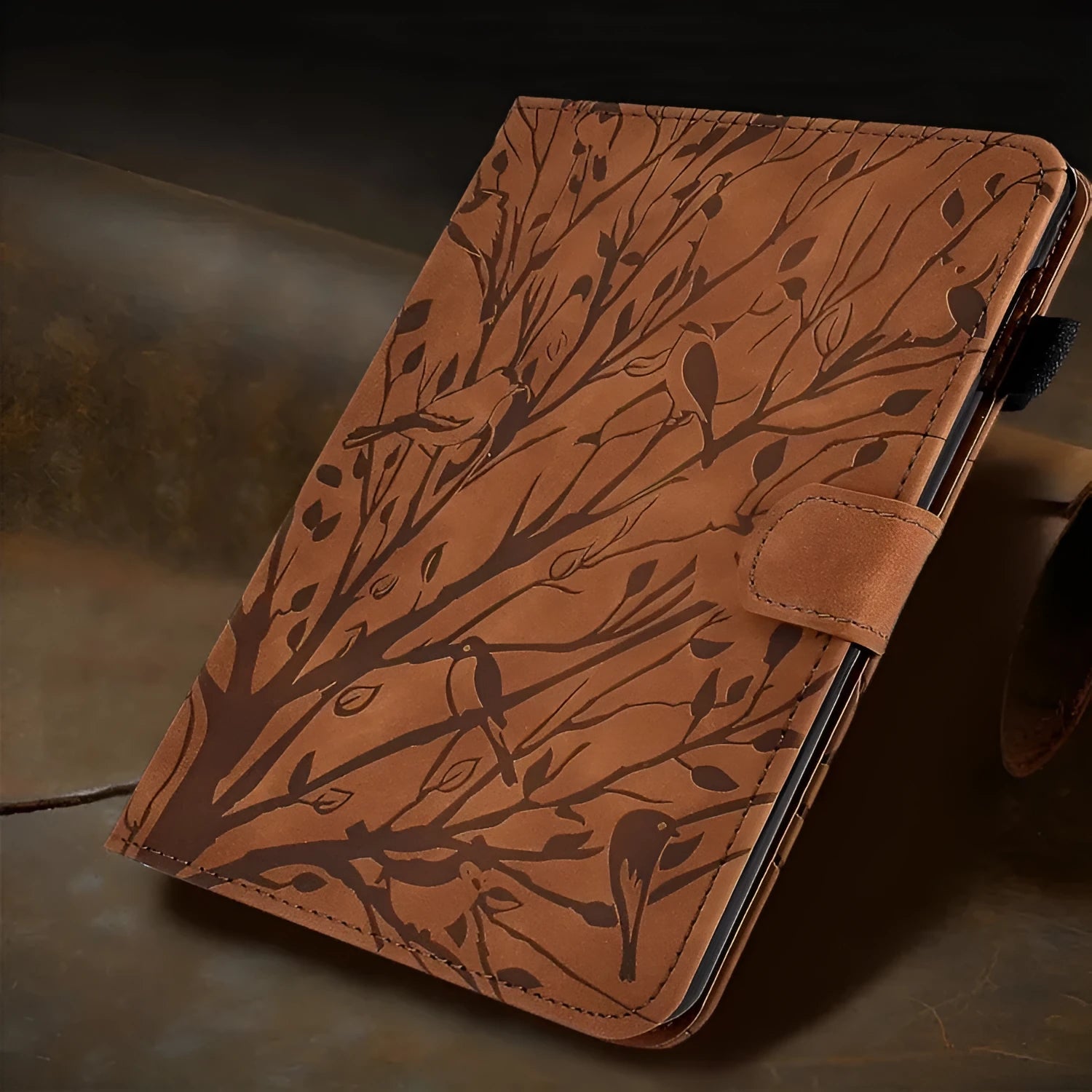 Leather-look tablet protective case with integrated stand in black, shown propping up a tablet.
