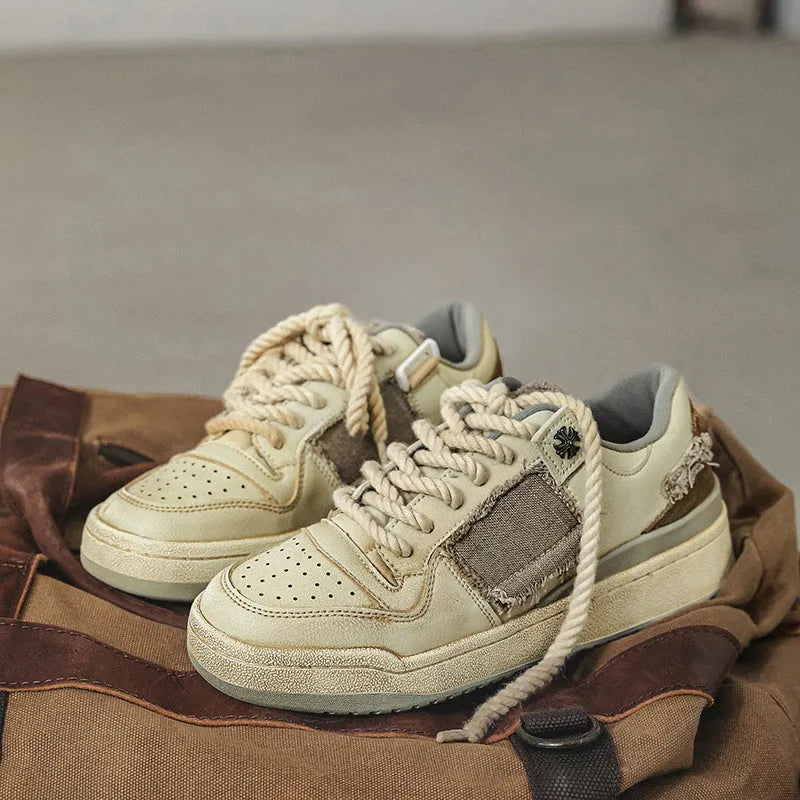 Beige vintage skateboard shoes with patch design, low-top cut, and round toe