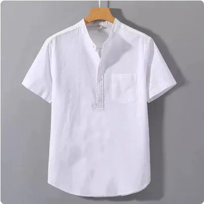 Man wearing a beige loose-fit short sleeve linen shirt with a stand collar.