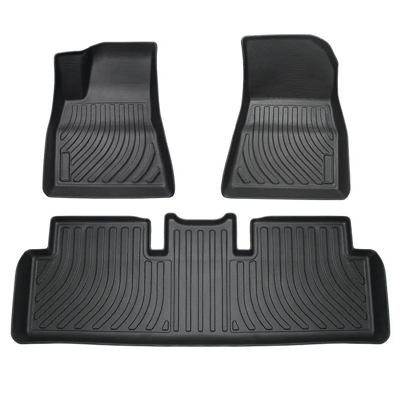 Black rubber floor mat for Tesla car interior with textured TPE footrest section.