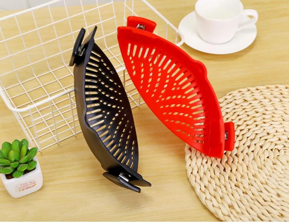 Silicone clip-on kitchen strainer attached to pot rim draining liquid