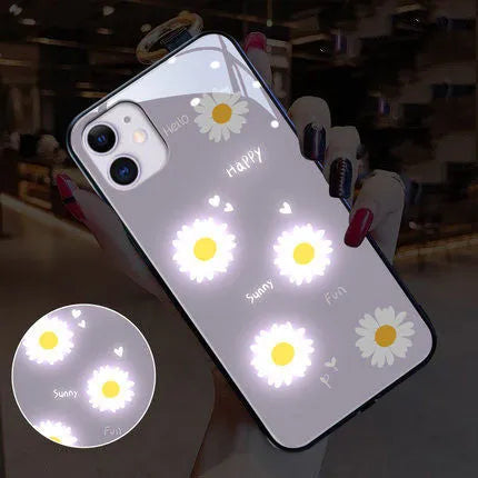 White iPhone case with painted daisy design and illuminated voice-activated colour light.