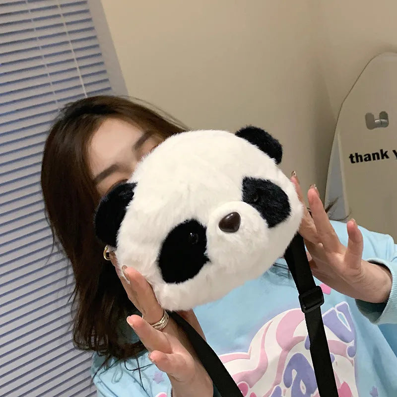 Soft plush panda head design crossbody bag shown in cylindrical shape.