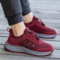 Men's and women's casual slip-on sneakers with mesh upper and elastic band in black, dark grey, purple, and purplish red.