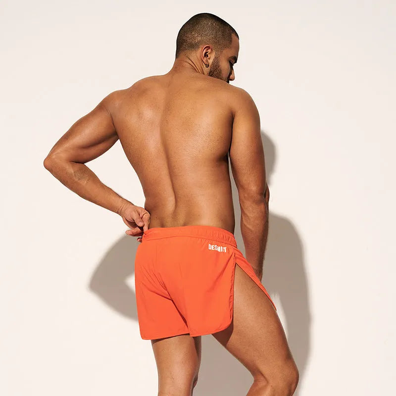 Men's loose beach shorts in orange red, fluorescent green and black colours with micro elasticity fabric