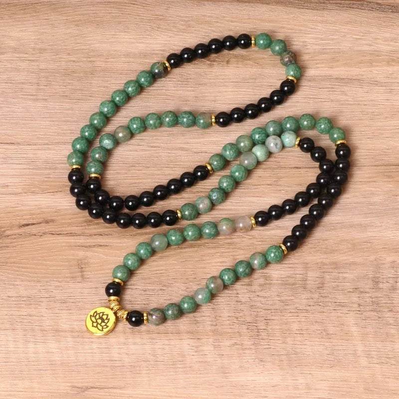 Green and black alloy beads on a stretch elastic bracelet band.