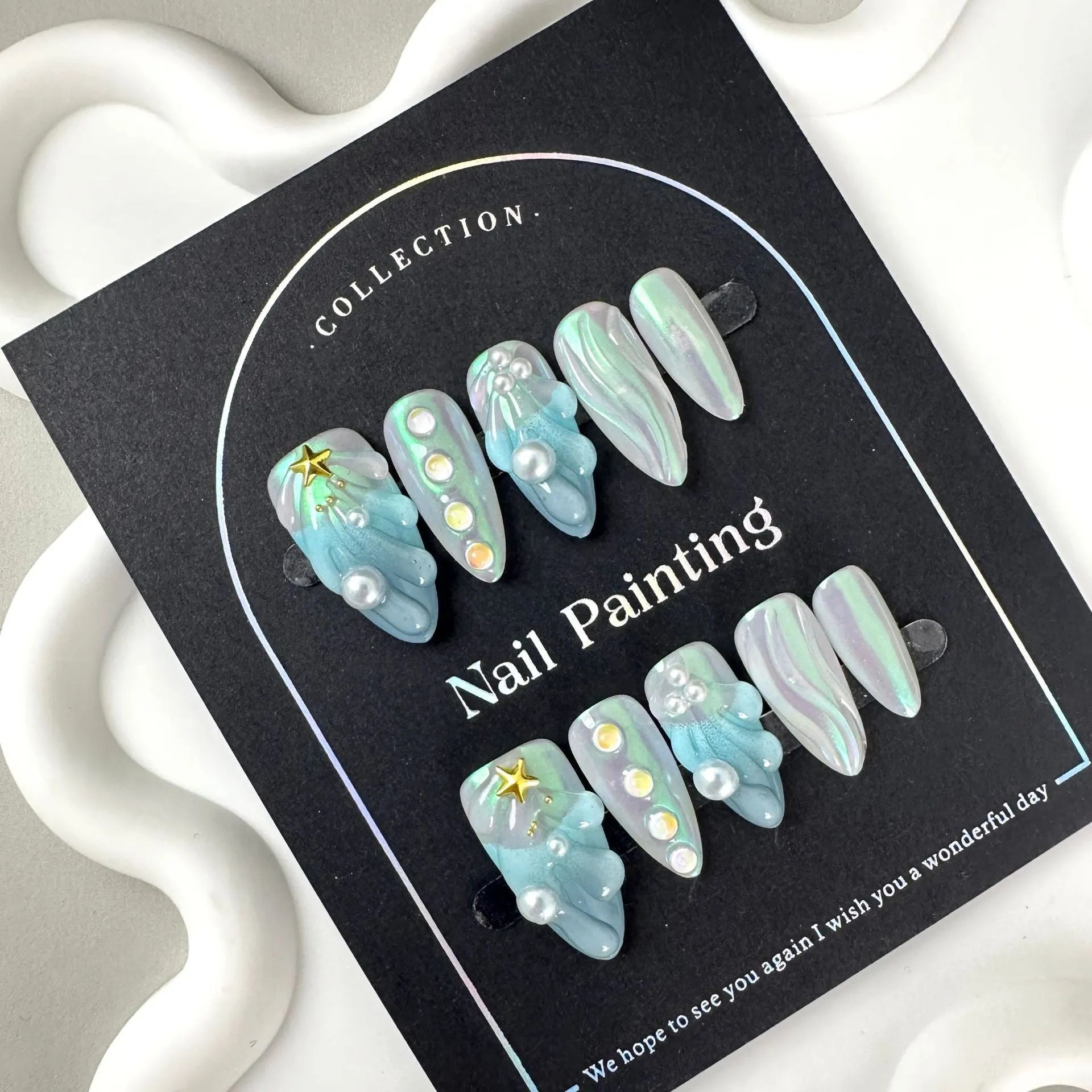 HAILANG blue shell pattern plastic artificial nail tips set showing sizes XS, S, M, L
