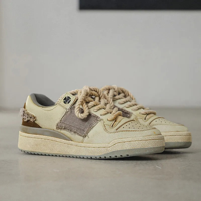 Beige vintage skateboard shoes with patch design, low-top cut, and round toe