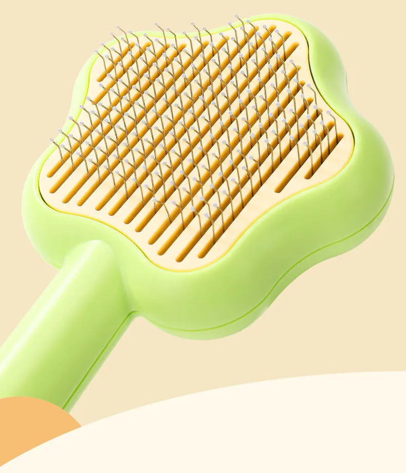 Green self-cleaning stainless steel cat comb with needle teeth on a 20cm handle.