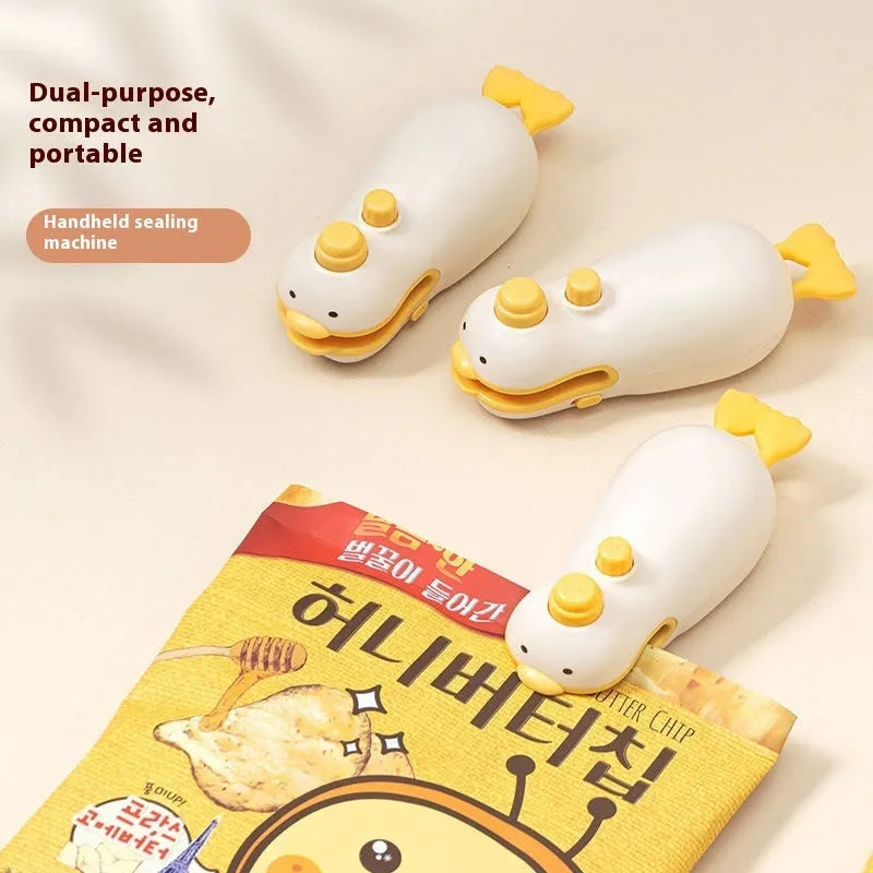 Small yellow duck animal jacquard style rechargeable sealing machine with charging cable.