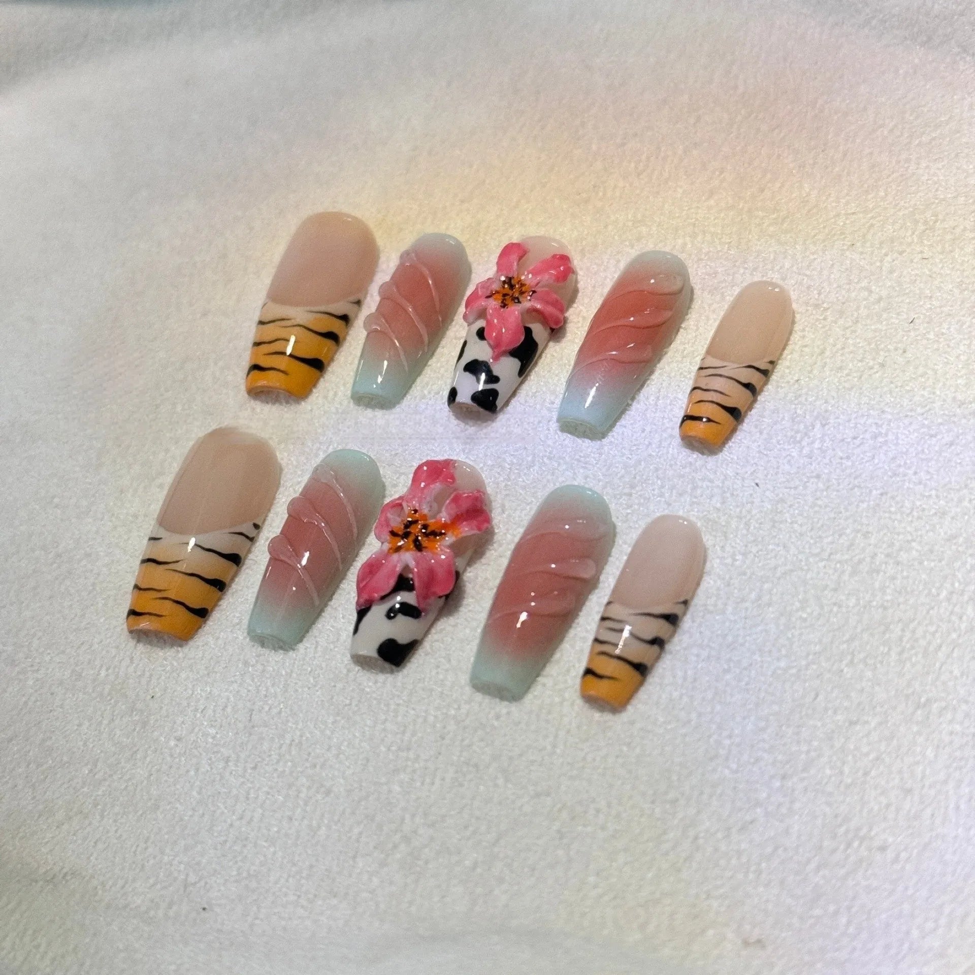 Zebra pattern lily hand carving nail art set with embossed flower and leopard print designs.