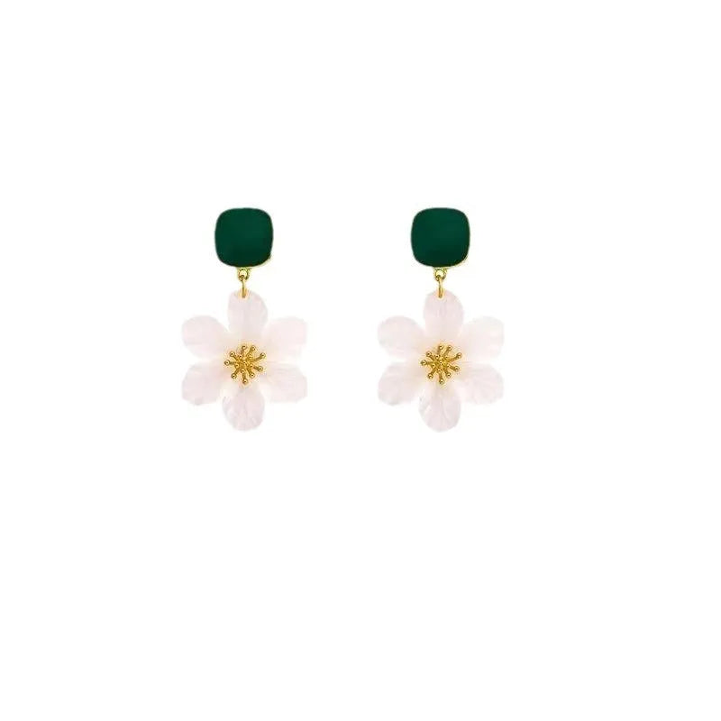 A pair of dark green alloy drop earrings with a floral design and clip-on fittings.