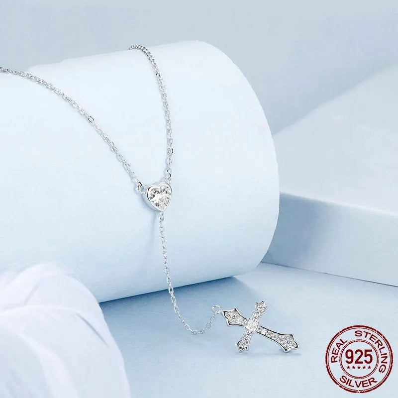 Simple silver love cross pendant necklace with O-ring chain on a female model, colour BSN384.