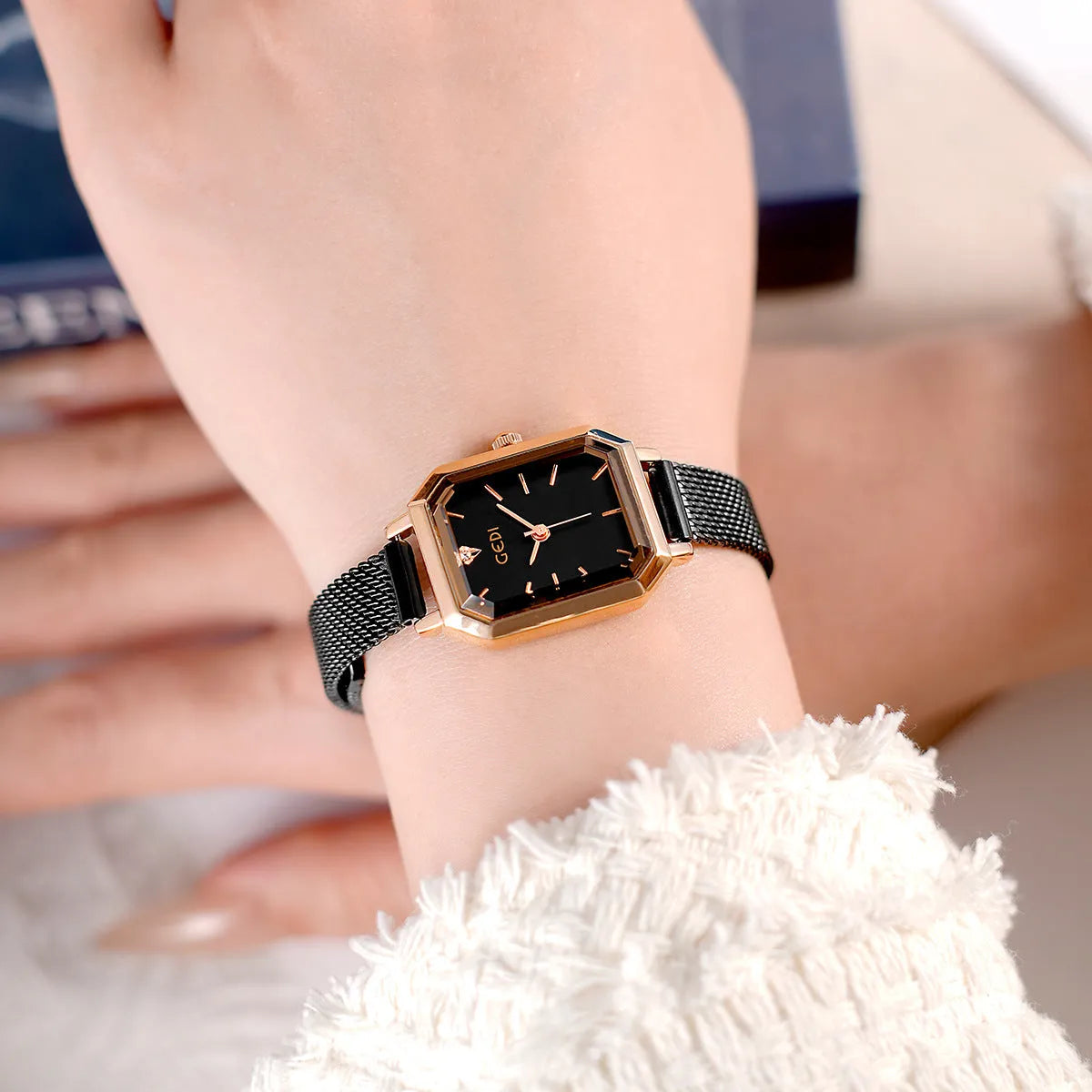 Square rose gold casual watch with black dial and black leather strap showing 8mm thickness